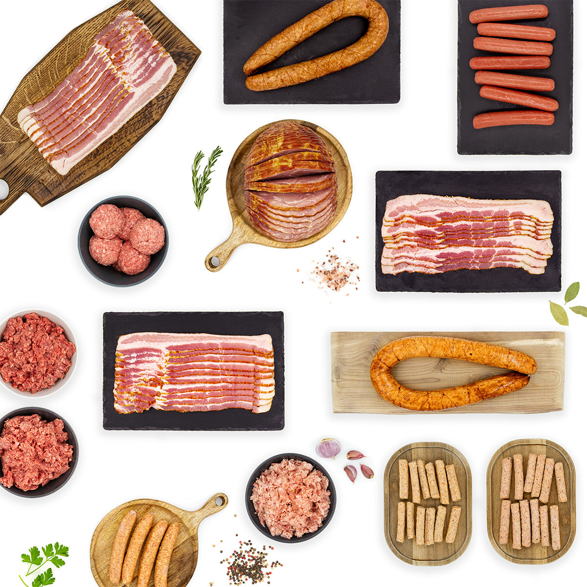 The Ultimate No Sugar Meal Prep Bundle lifestyle image featuring bacon, connected sausage, breakfast sausage links, ground sausage, ground beef and bison, ham, and hot dogs