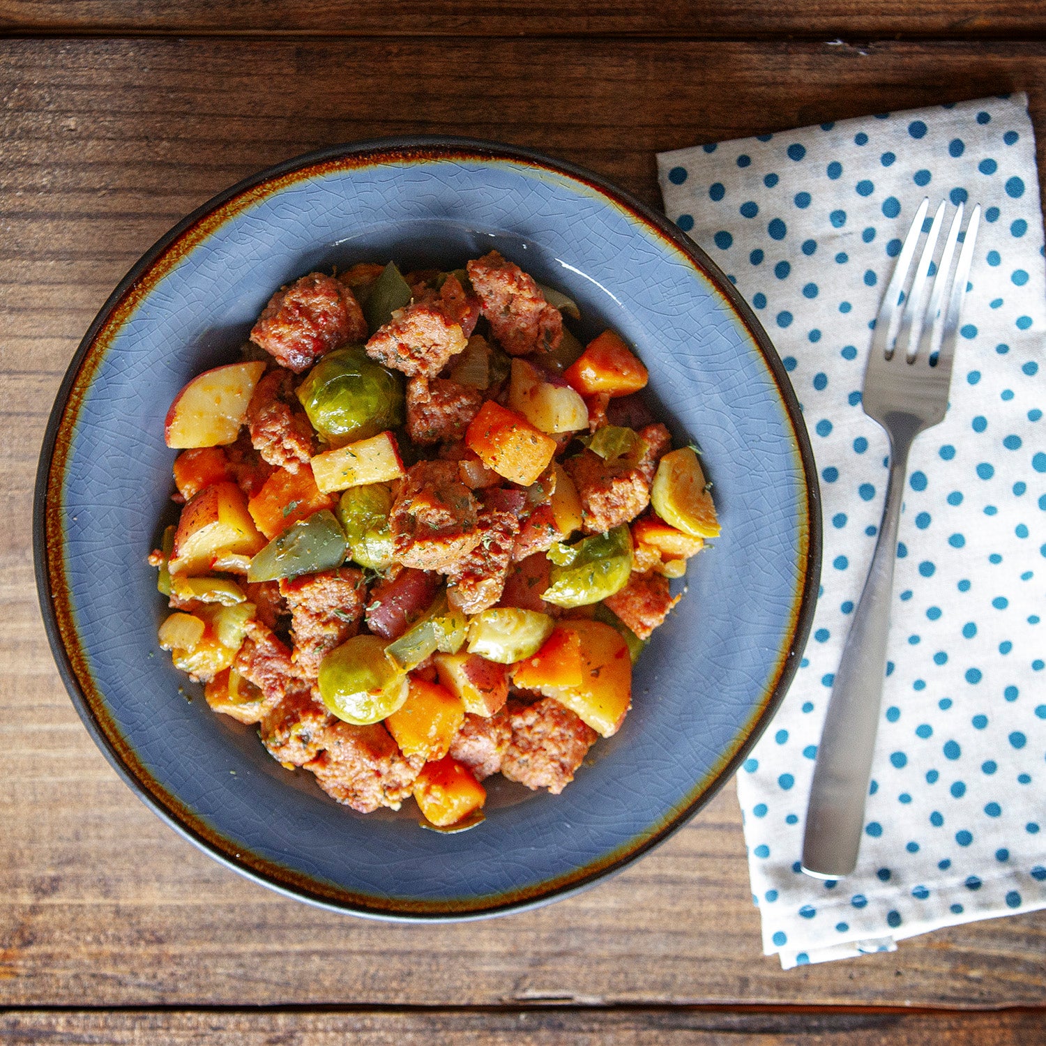 no sugar added chorizo stir fry lifestyle image on plate with fork and napkin