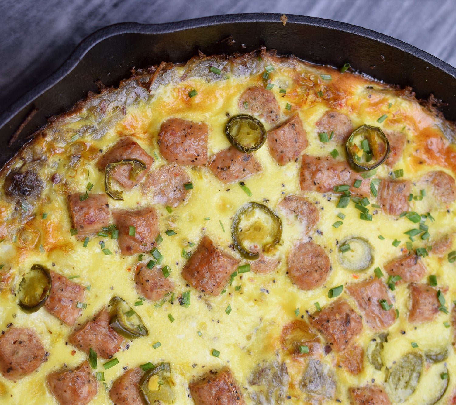 Hot dish filled with chopped up Spicy Breakfast Sausage Links, jalapeno, and green onions.